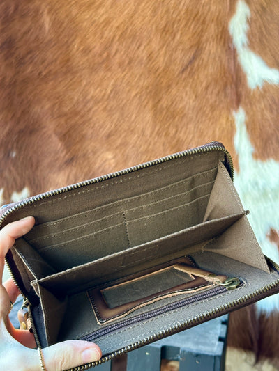 Green and brown woven saddle blanket wallet with multiple compartments for organization.