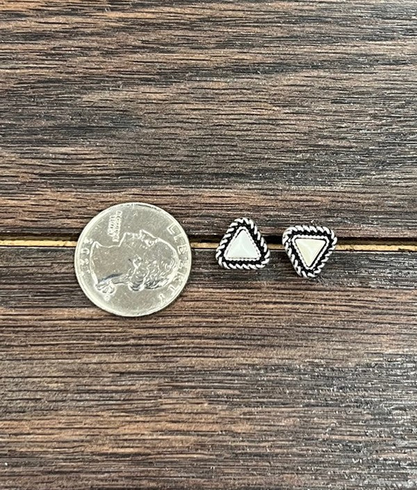 Western-inspired faux white buffalo stud earrings with intricate silver rope detail, displayed next to a quarter for size comparison.