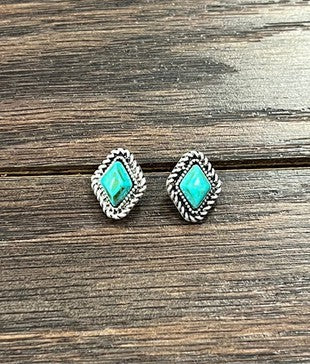 Flat lay of David Turquoise Stud Earrings displaying their simple yet elegant Western charm.