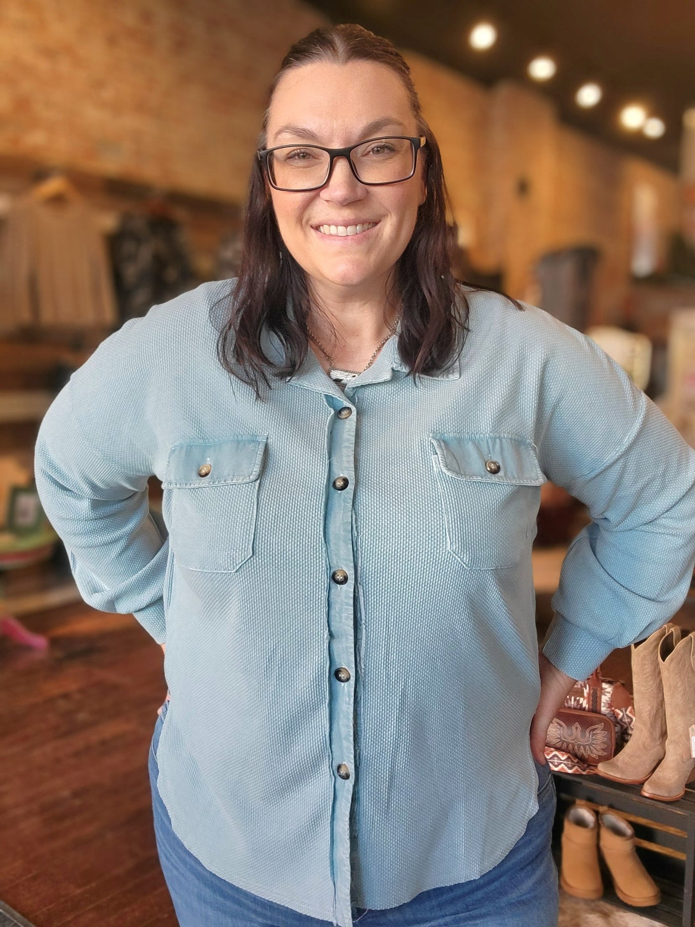 A Broker Leather employee modeling the Diana Textured Knit Shacket in blue.