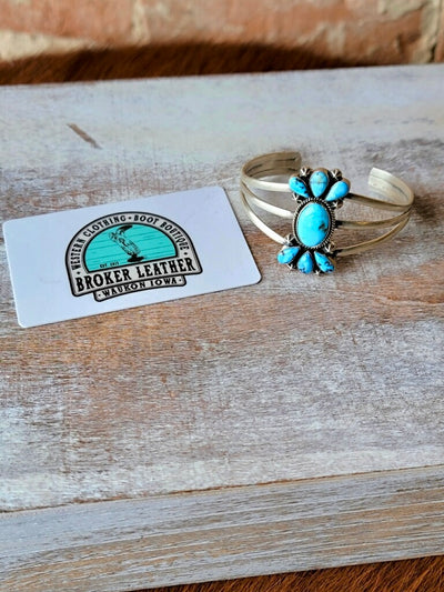 Heirloom-Quality Western Jewelry – Durango Authentic Turquoise Bracelet photographed next to a plastic gift card for size relevance.