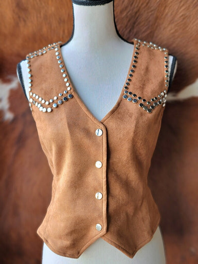 Fashionable suede vest with metallic studs arranged in an eye-catching pattern, ideal for a bold outfit statement.