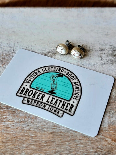 Dutton Authentic Wild Horse Stud Earrings in Sterling Silver photographed next to a plastic gift card for size relevance.