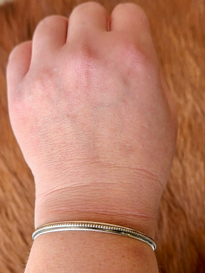 Handmade Sterling Silver Stacking Bracelet with Classic Design modeled on a wrist.