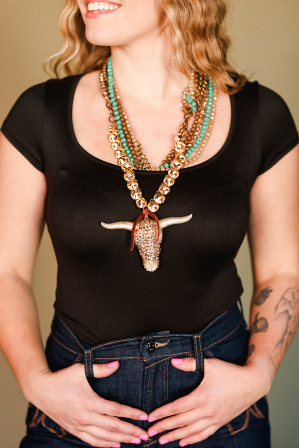 Broker Leather employee modeling our Elliott Crystal Bull Skull Necklace which is on sale for Cyber Monday.