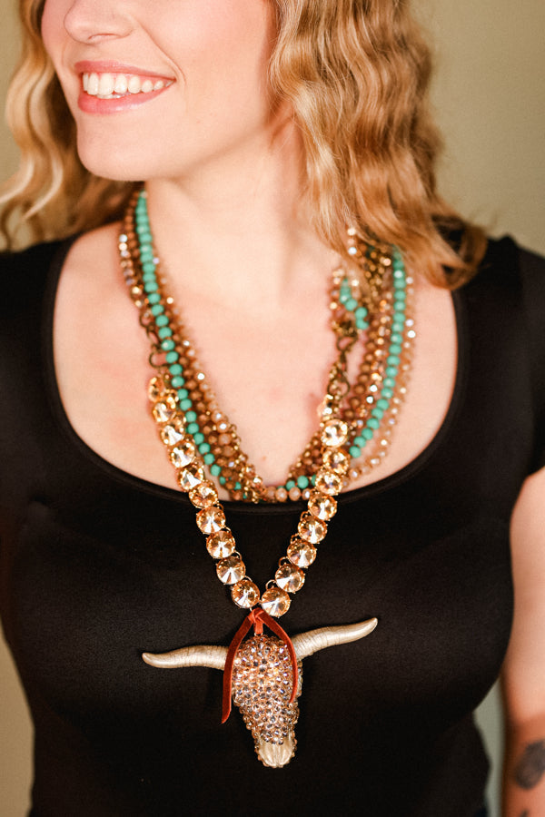 Closeup of a woman modeling our Elliott Crystal Bull Skull Necklace.