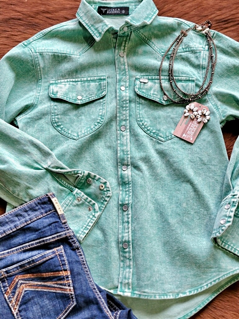 Broker Leather outfit style inspiration flatlay featuring Ariat denim jeans and the new Elva Denim Mineral Wash Pearl Snap Shirt in Jade – Western-Inspired Style.