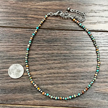 Timeless cowgirl-inspired Navajo pearl and turquoise gemstone necklace, nickel and lead-free for sensitive skin, photographed next to a quarter for size comparison.