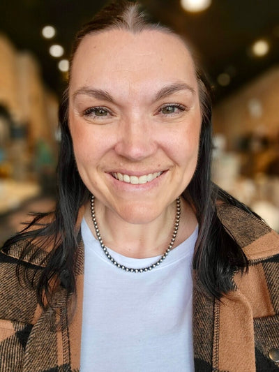 Western cowgirl wearing the Etta Navajo Pearl Necklace with everyday ranch attire.