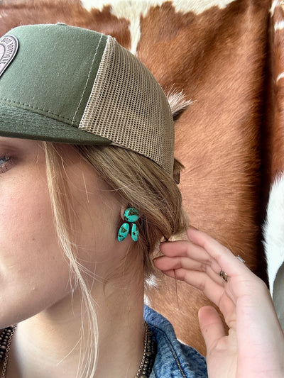 Small Euchre Turquoise Clay Stud Earrings paired with Western-inspired ballcap and denim top.