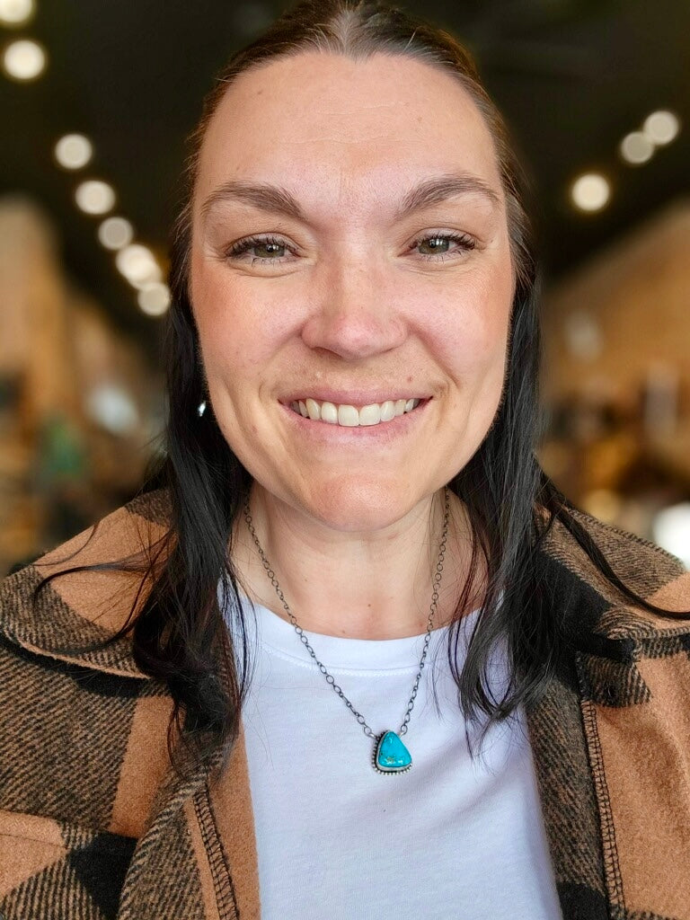 Authentic Blue Ridge Turquoise pendant necklace with unique marbling modeled by staff for size relevance.