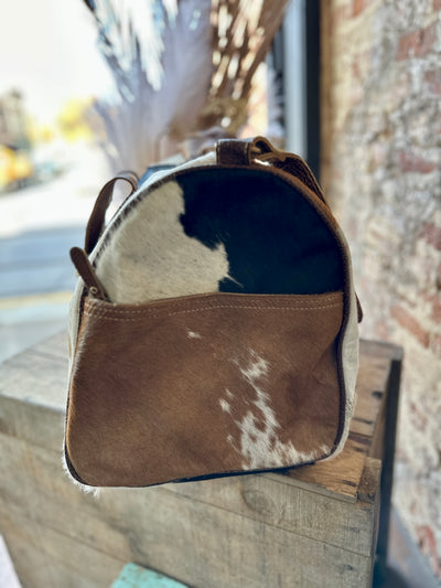 End view of our Sigmund Cowhide & Leather Weekender Bag.