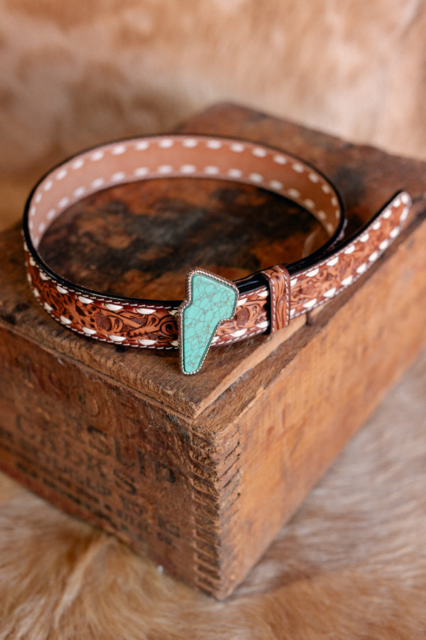 Close-up of the Finley Lightning Bolt Belt, featuring floral tooled design and intricate buckstitch details.