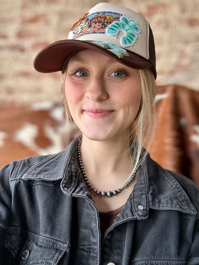 Broker Leather employee, Grace, modeling the Flynn Faux Navajo Pearl Necklace, styled as a statement Western accessory.