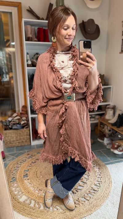 Model from Broker Leather in this western-inspired rose clay kimono paired with jeans and boots for a casual, stylish outfit.