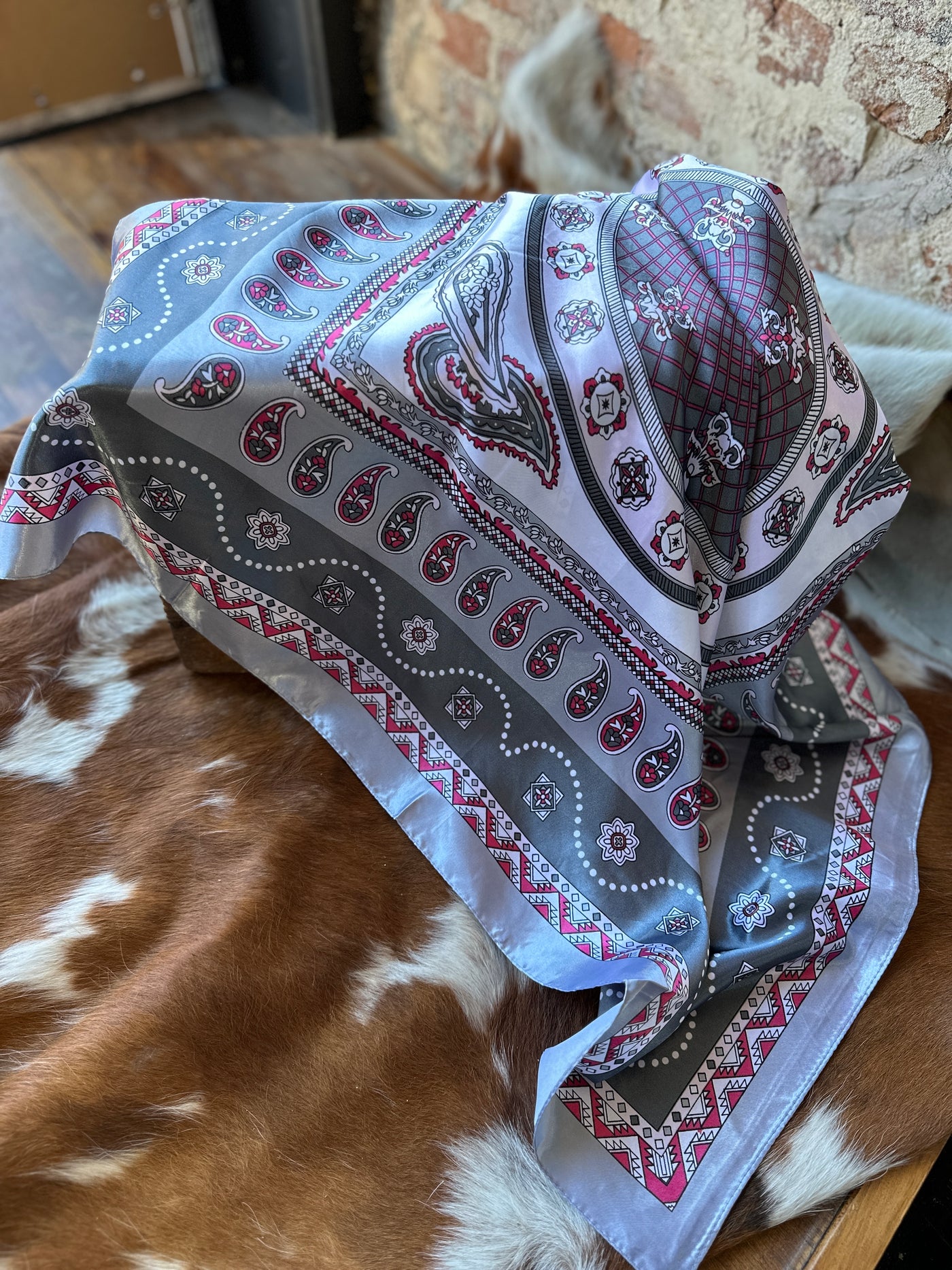 Flatlay close up showing the details of our Rossio Paisley Wild Rag [Grey & Pink].