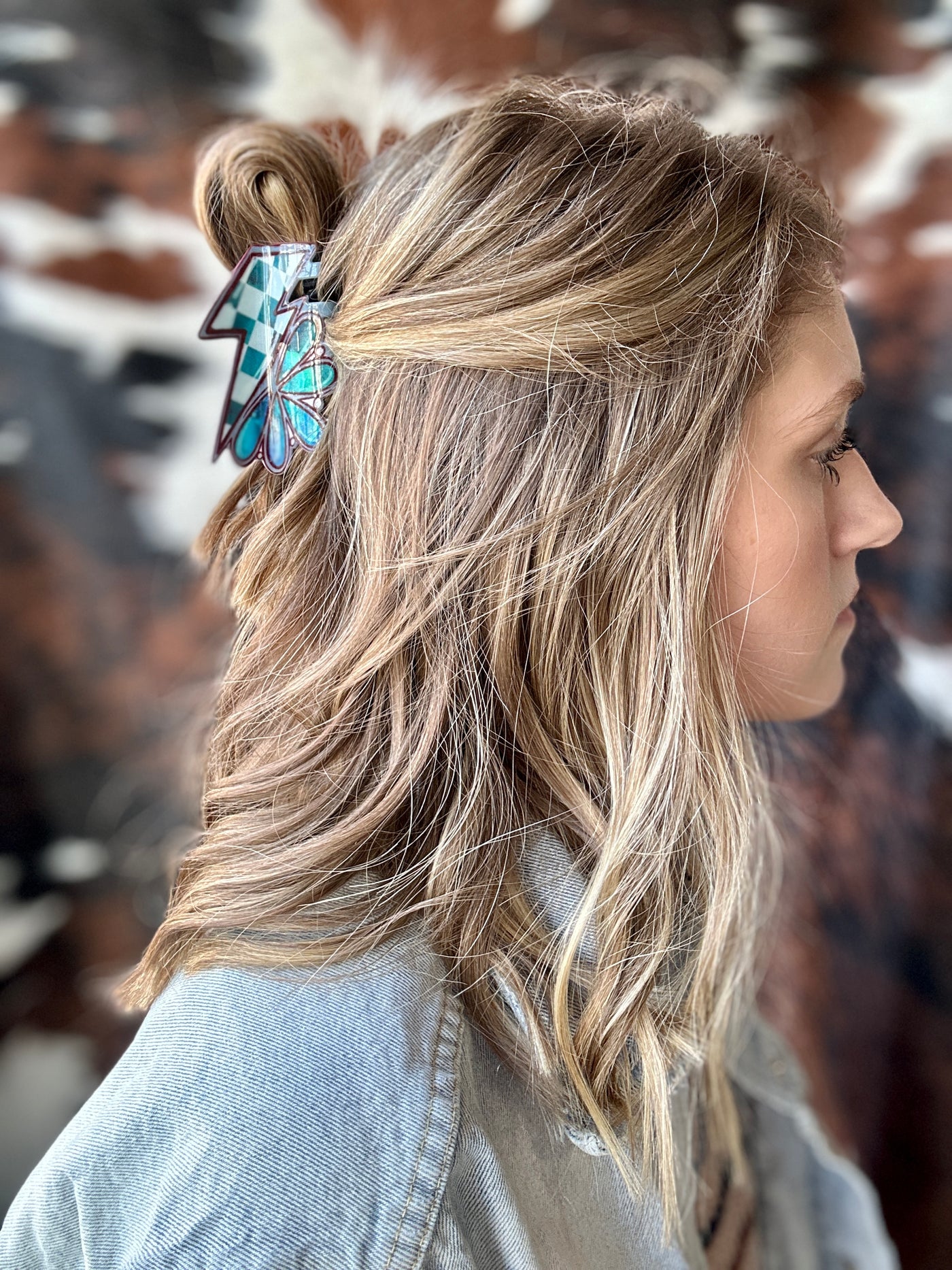 A woman modeling our Kylie Turquoise & Lightning Bolt Claw Clip in her hair.