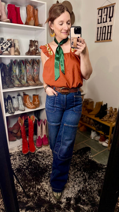 Feminine and Western-inspired, the Gertrud Embroidered Ruffle Sleeve Tank in Rust is a must-have for any modern cowgirl.