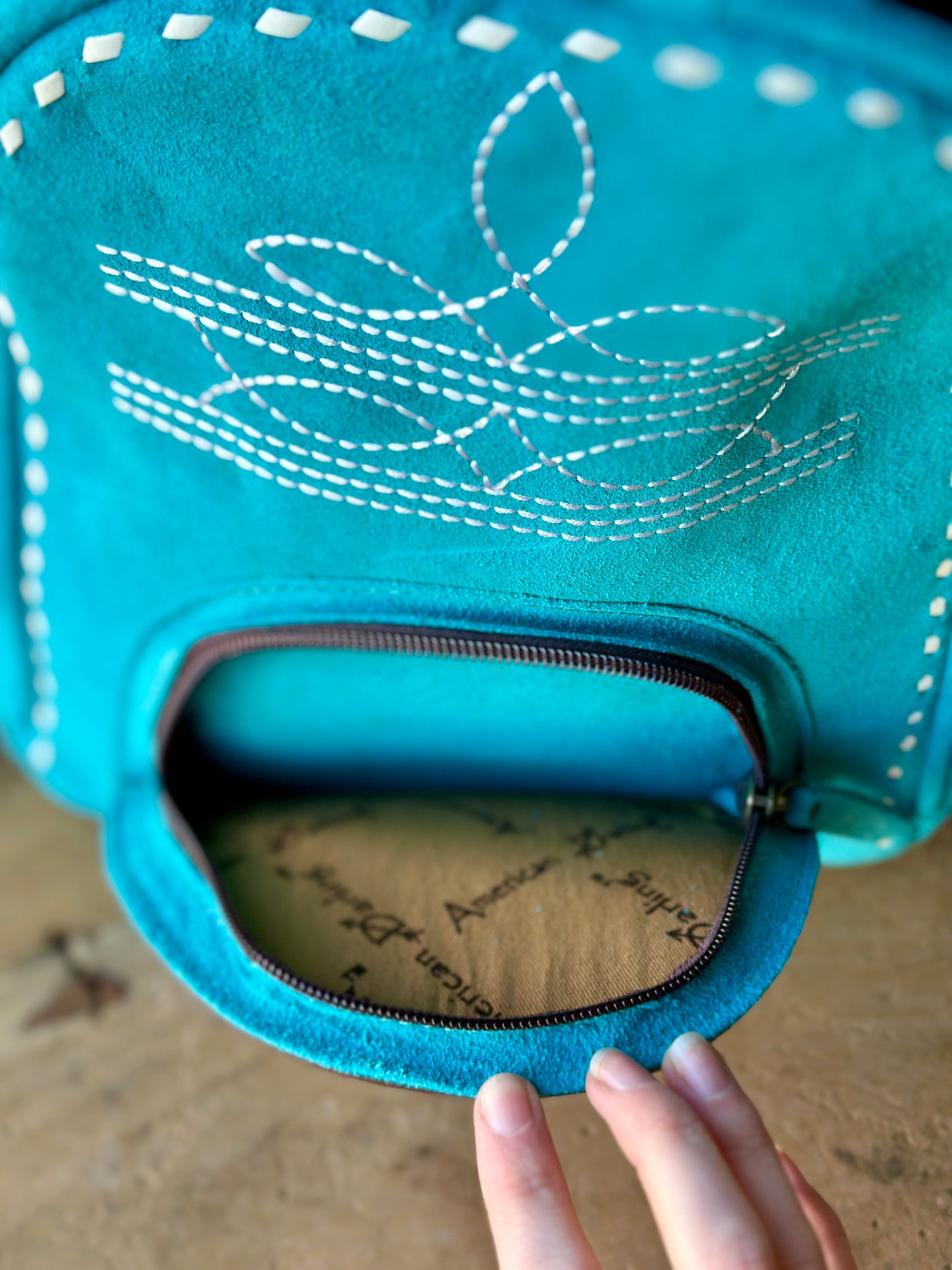 Close-Up of Boot Stitch Pattern on Suede Leather Backpack and front pocket.