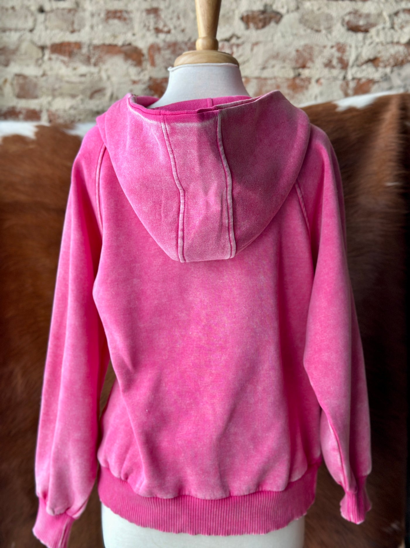 Backside view of the hot pink mineral-washed quarter-zip pullover hoodie featuring a relaxed fit and soft fleece fabric.