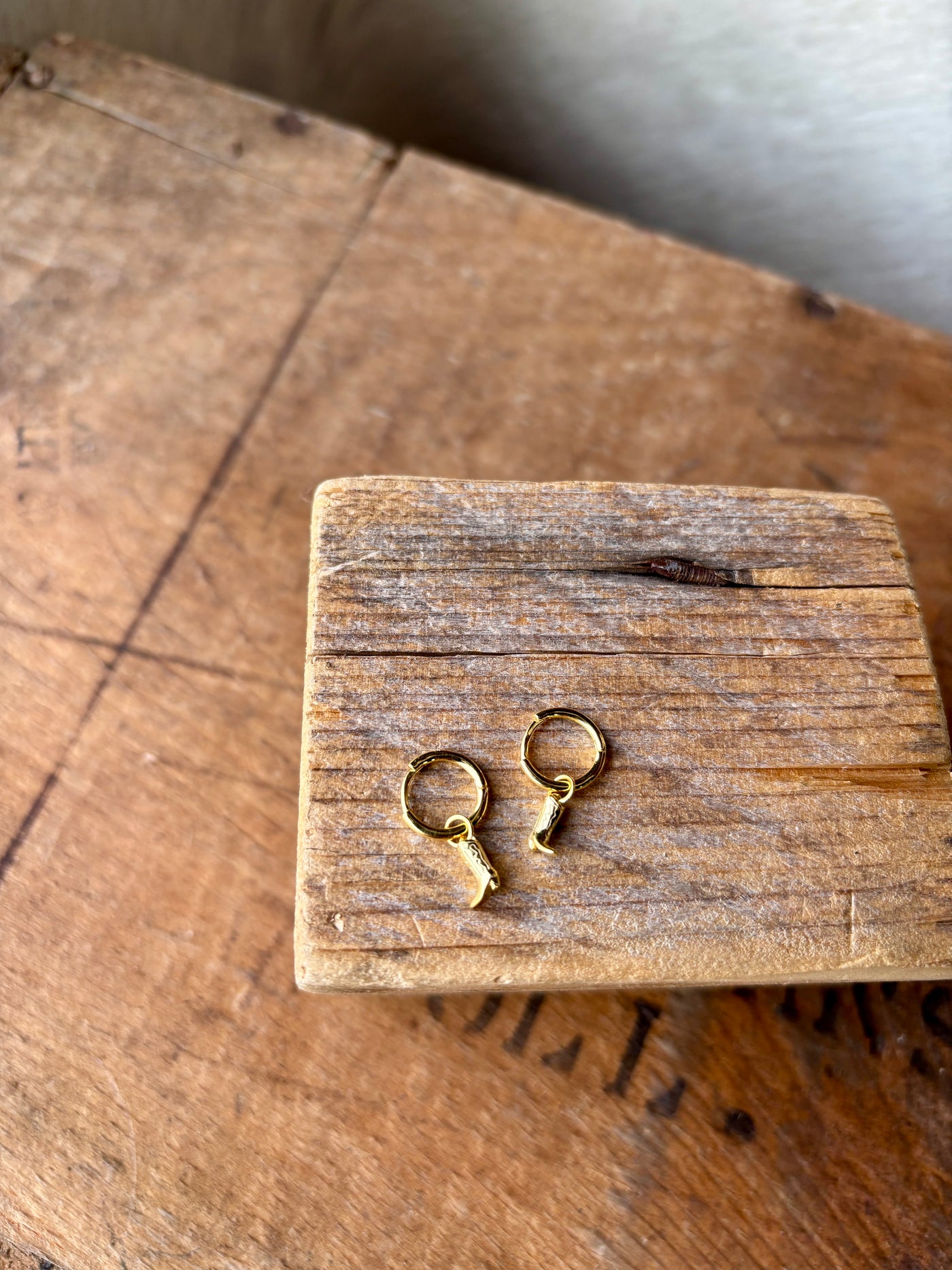 A dainty pair of adorable cowboy boot charmed earrings, blending a nod to the Wild West.