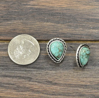 Turquoise teardrop stud earrings with silver borders, perfect for everyday Western wear- photographed next to a quarter for size comparison.