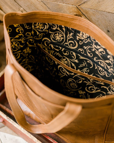 Stylish and functional tooled leather tote for everyday or travel use.