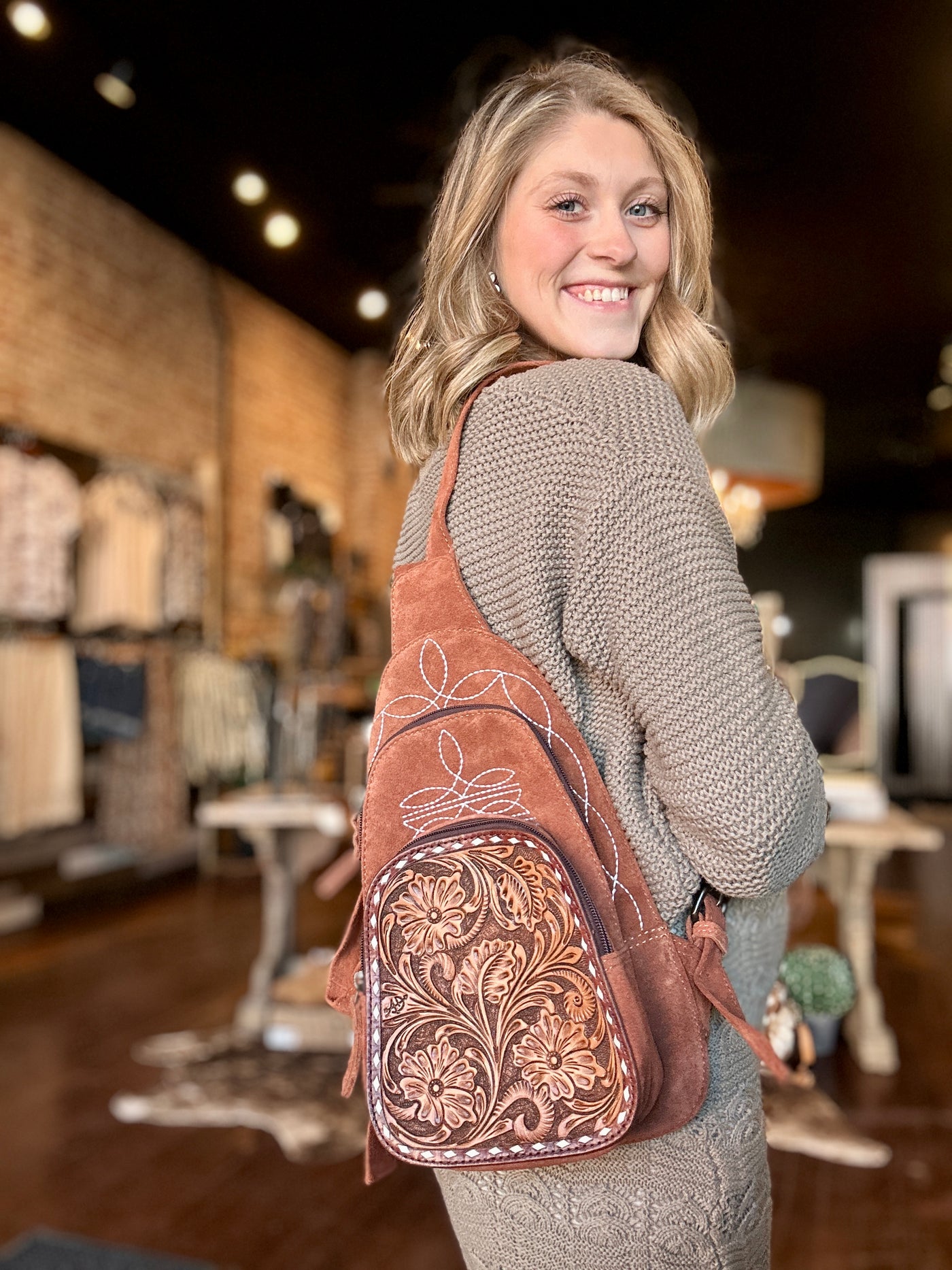 Compact and Stylish Rust Leather Backpack for Everyday Use worn by Broker Leather employee, Grace, for size relevance.