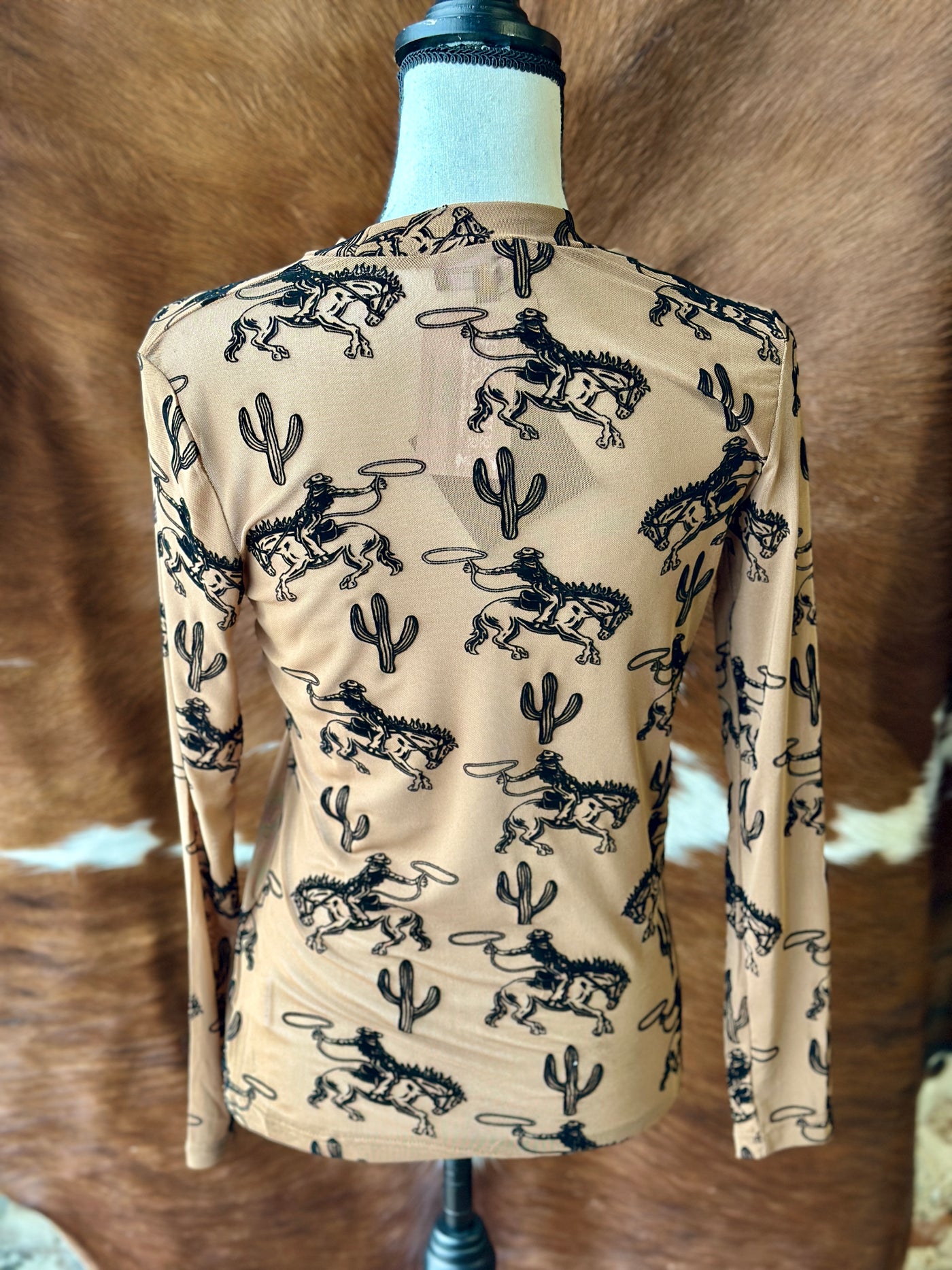 Super soft long sleeve mesh top with raised black patterns of cowboys and cacti on a brown base, ideal for adding a textured touch to your outfit.