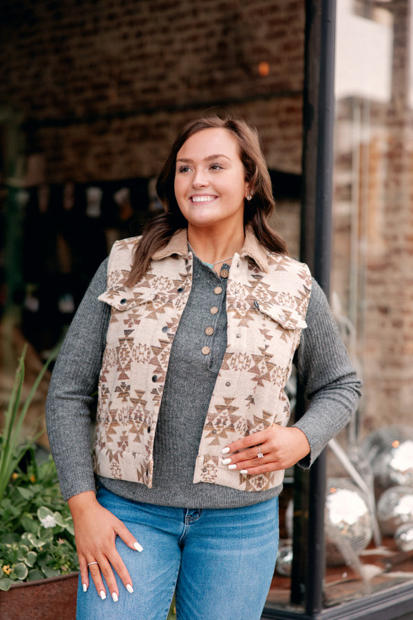 A model at Broker Leather wearing the Hooey Binx Mommy-n-Me Vest which is neutral colors: Ivory/Brown and Aztec Patterned.