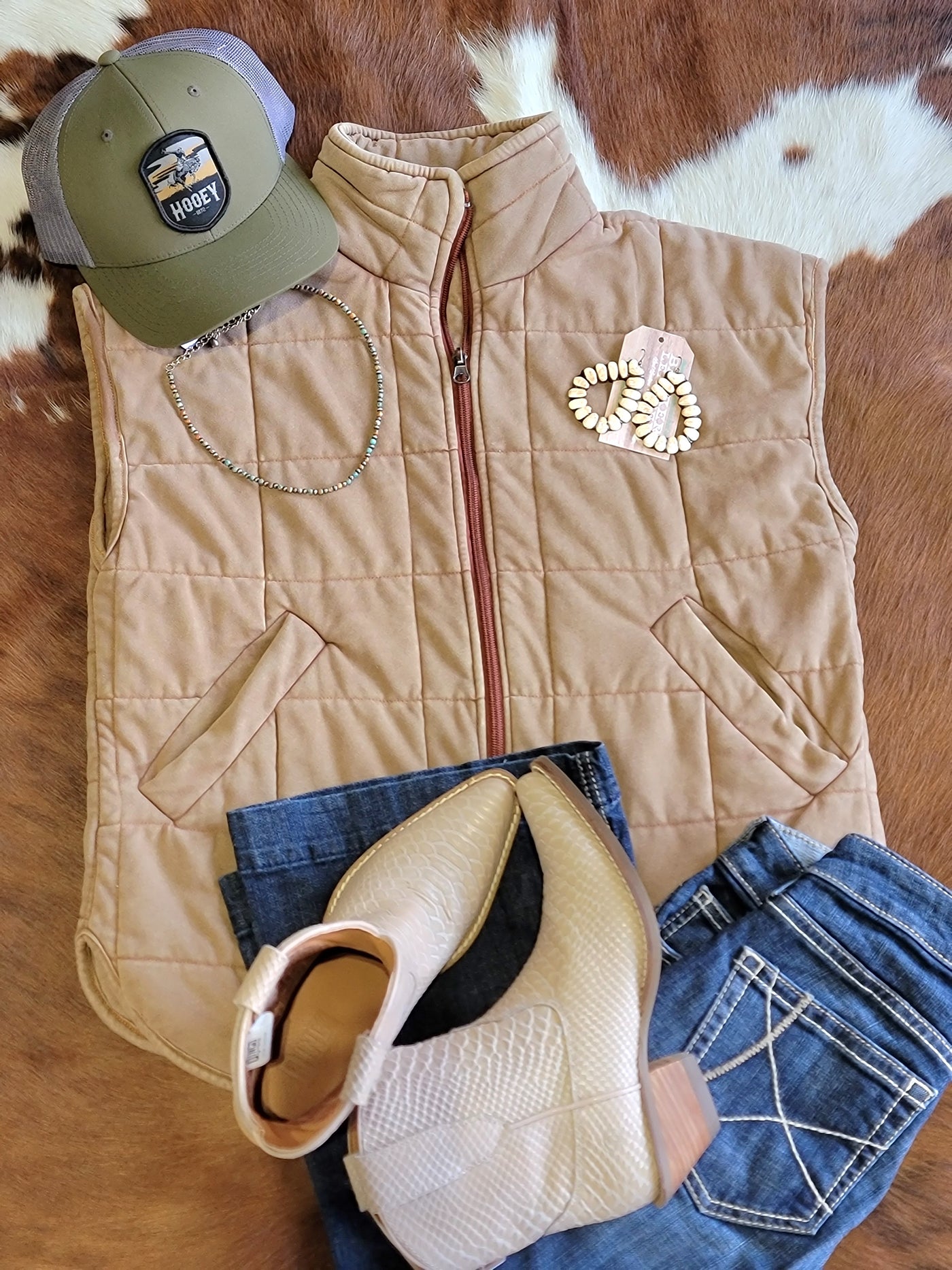 Flatlay of an outfit featuring our Brenley Brown Quilted Vest and Dingo Boots.