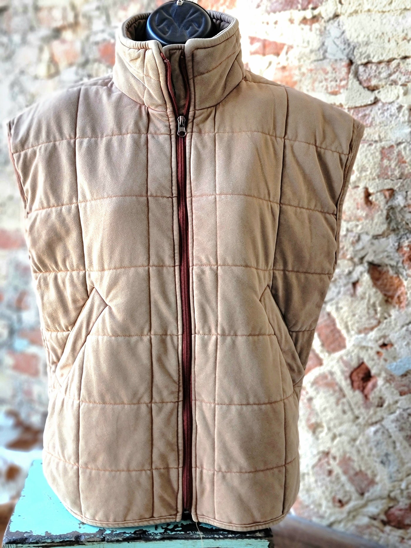 The front side of our Brenley Brown Quilted Vest modeled on a mannequin.