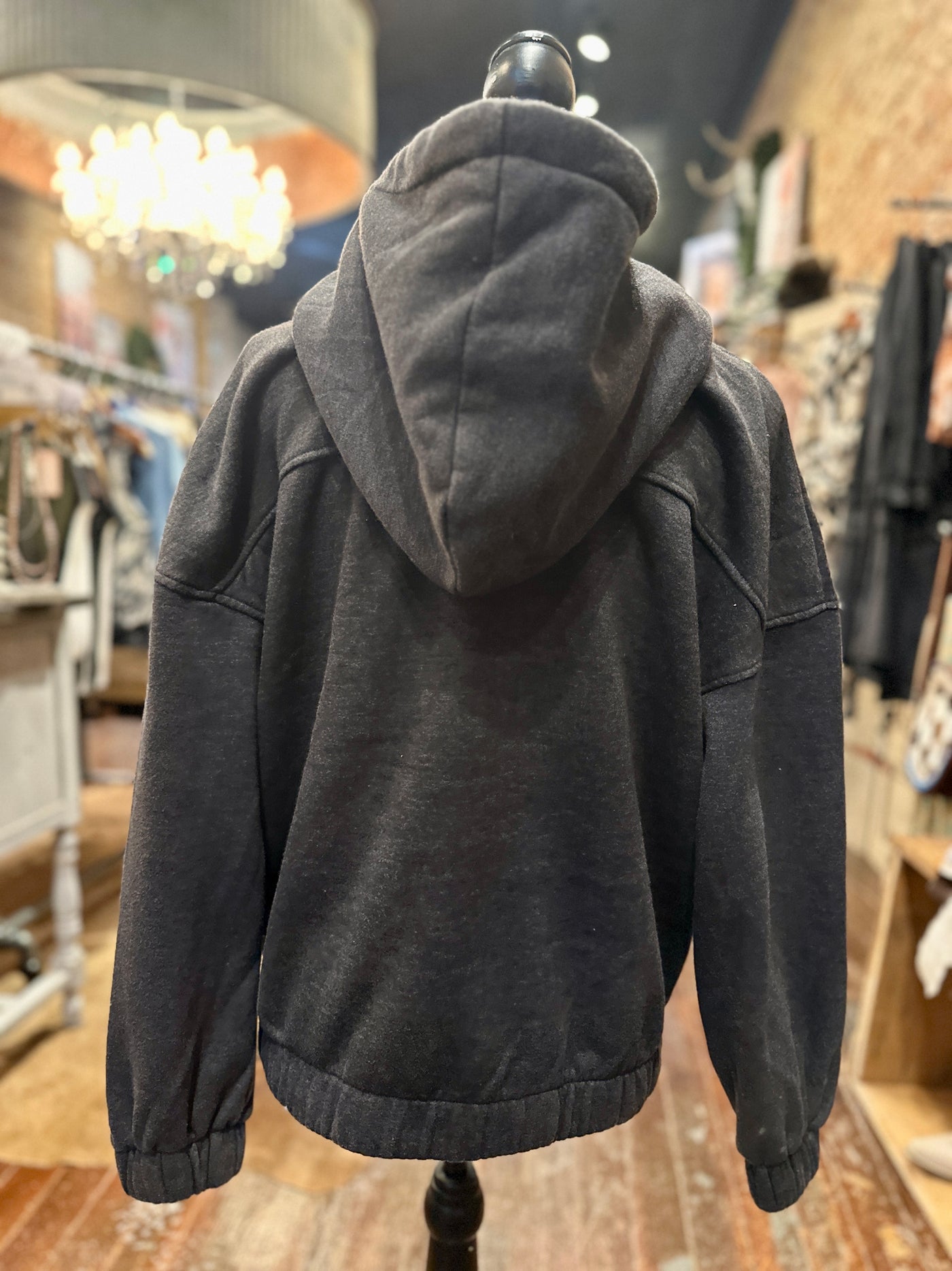 Back view of versatile hooded sweatshirt, blending comfort and style for any casual occasion.