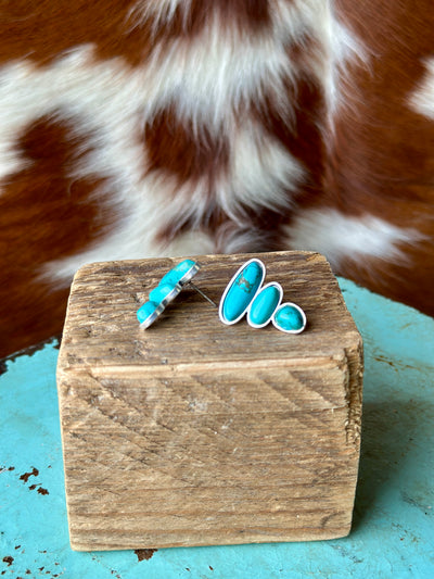 The Jeep Turquoise Stud Earrings, with natural stone-like faux turquoise in an alloy metal setting, designed to make a statement.