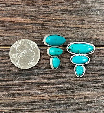 Detailed view of the Jeep Turquoise Stud Earrings, highlighting the unique color and marbling of the faux turquoise stones.