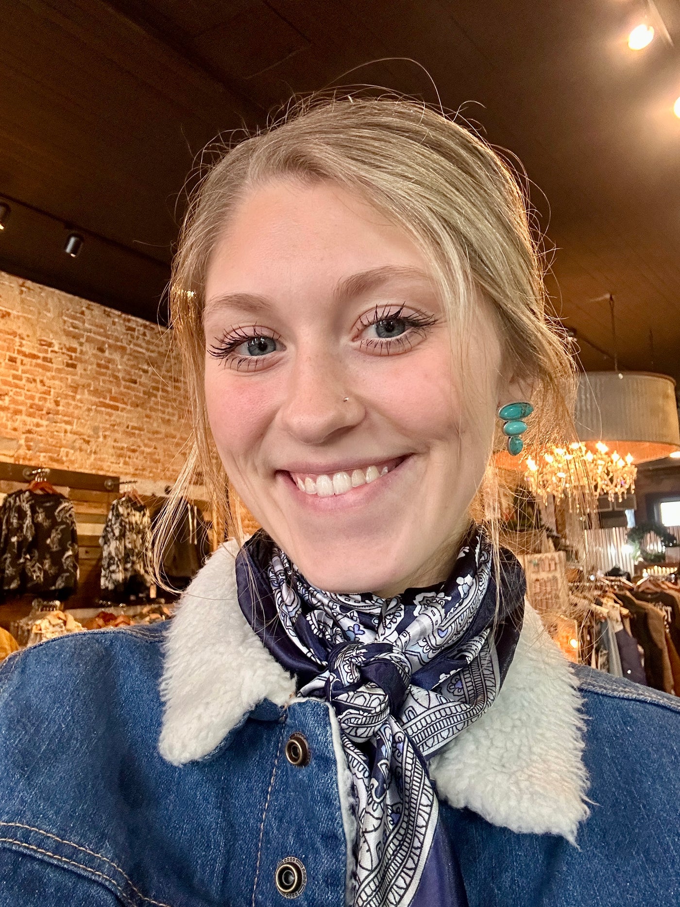 Model wearing the Jeep Turquoise Stud Earrings, adding a pop of turquoise to a casual Western-inspired outfit.