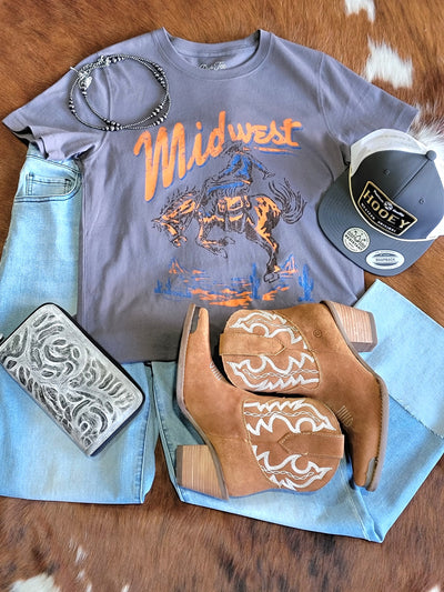 Broker Leather's Jenel Midwest Rodeo Graphic Tee featuring a cowboy riding a bucking horse paired with Dingo boots, Navajo Pearls, and a Hooey Hat.