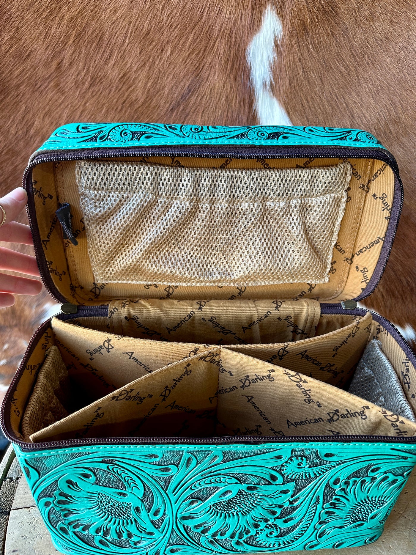 The Jessica Tooled Leather Makeup Bag in Aqua—a perfect blend of style and functionality for your beauty essentials.