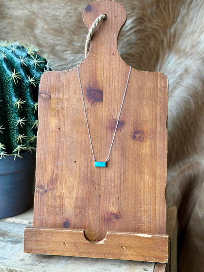 Kaela Turquoise Bar Necklace Styled against Western backdrop – Timeless and Versatile