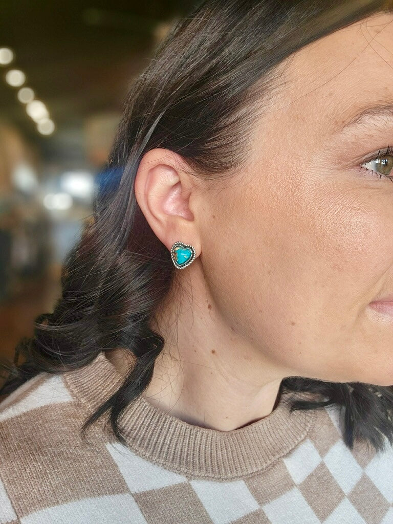 Small heart-shaped turquoise stud earrings with vintage silver plating for a classic cowgirl look.