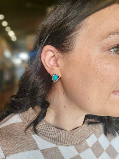 Small heart-shaped turquoise stud earrings with vintage silver plating for a classic cowgirl look.