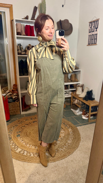 The Kallyn Striped Bowtie Blouse showcasing long balloon sleeves brings added style to an olive green romper.