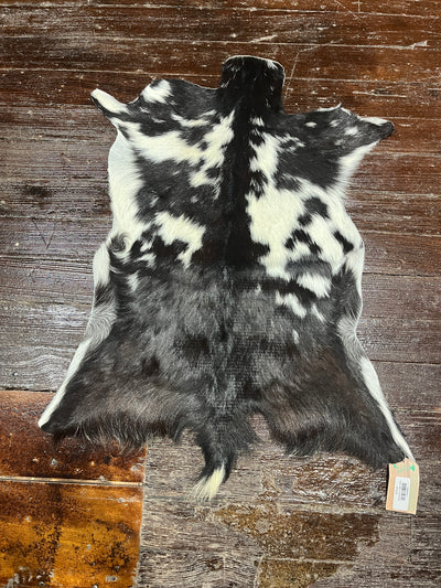 Full rug image of Keeaunna Black & White Genuine Goat Hide with rustic charm and modern functionality.