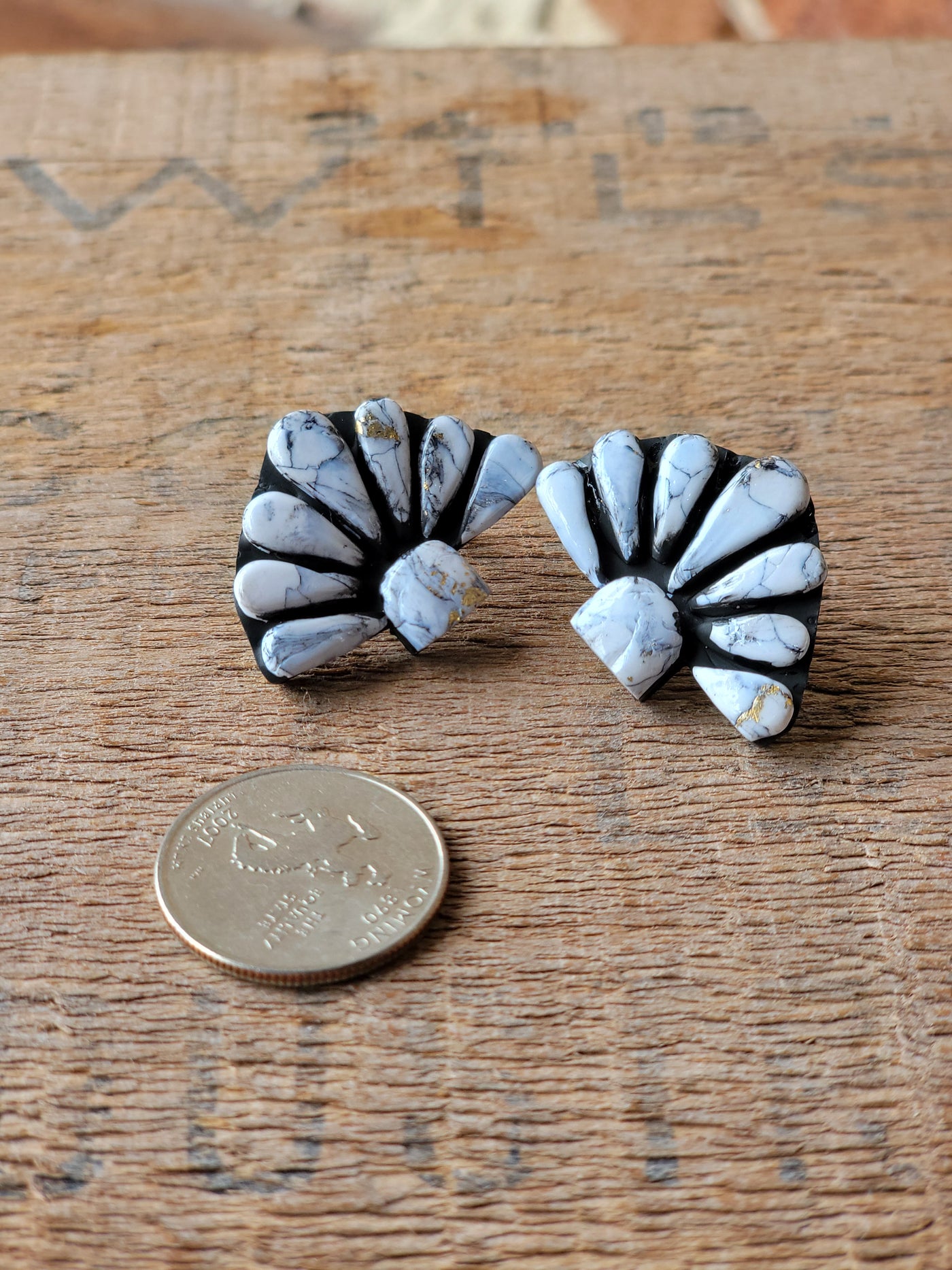 Flat lay of the Kelcie Clay Cluster Earrings displaying their one-of-a-kind craftsmanship and vibrant white color to resemble White Buffalo stones.