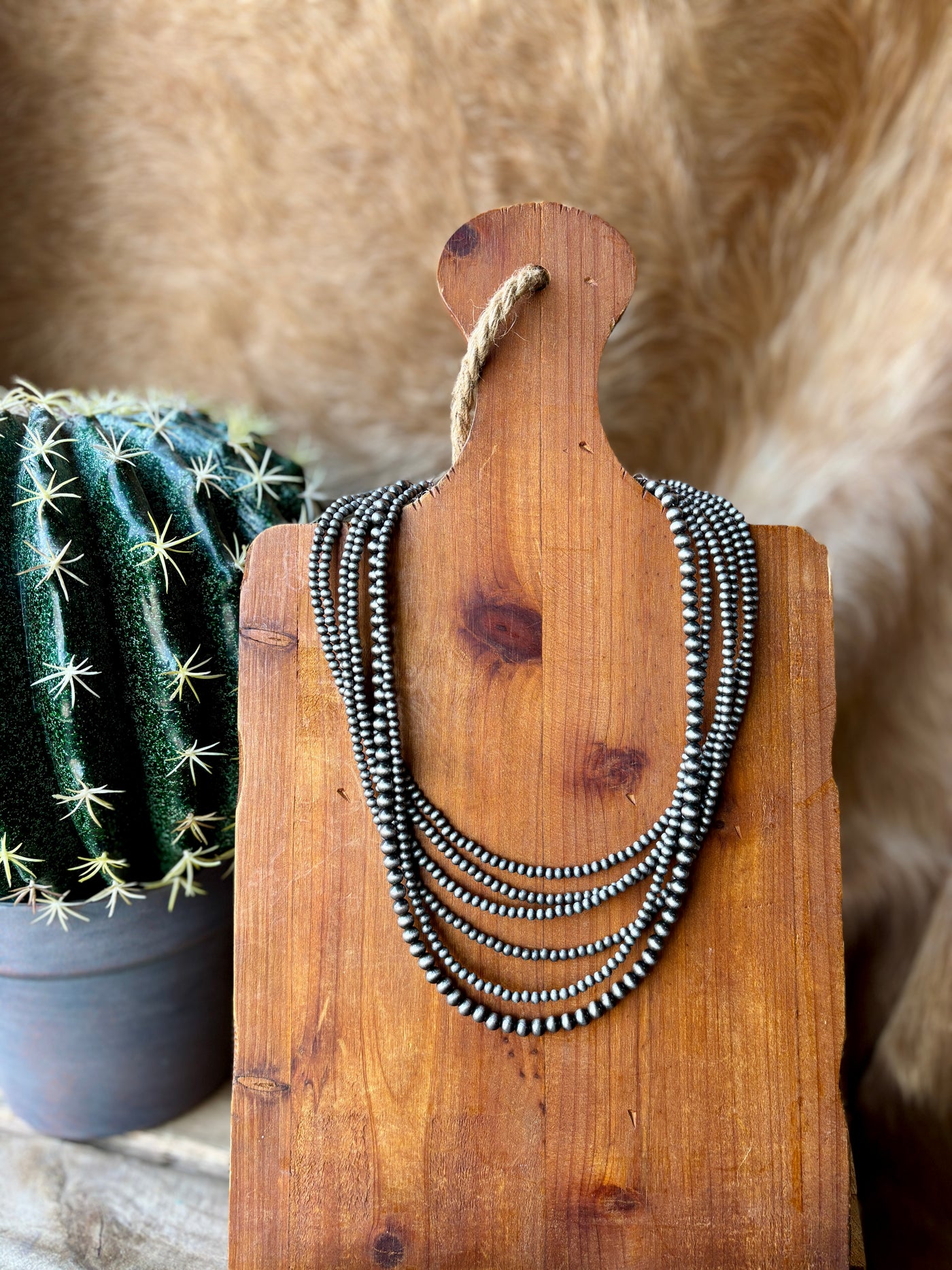 Western-inspired multi-strand Navajo pearl necklace with a secure clasp to prevent tangling and twisting.