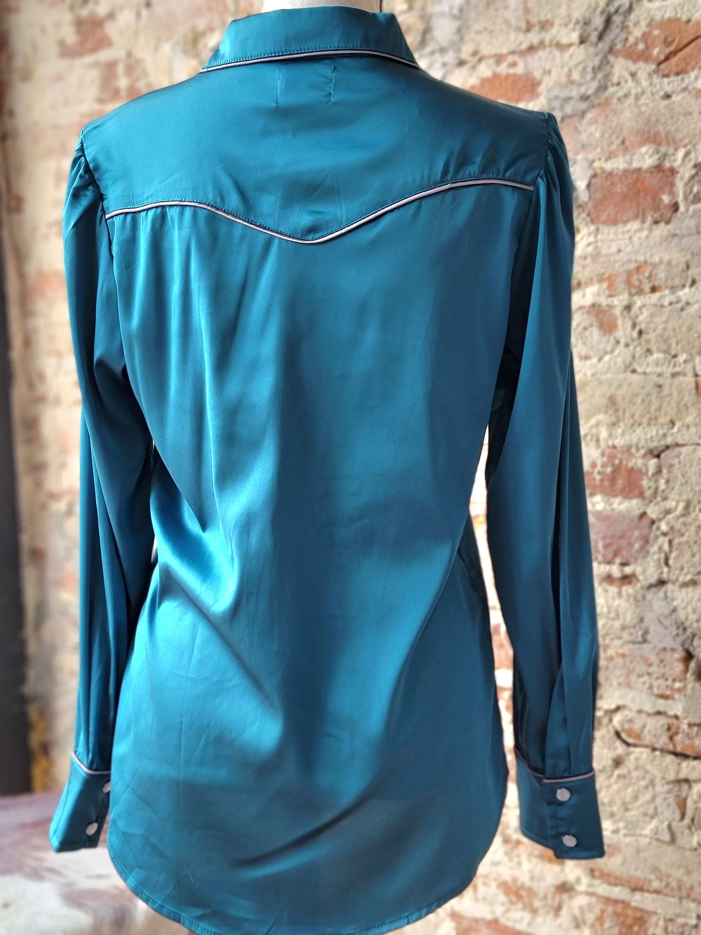 Back view of Lacey Turquoise Western Yolk Pearl Snap Top with Western yolk detail and smooth satin texture.