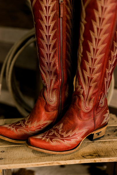 Close-up of Lane Lexington Boots showcasing the snip toe, detailed stitch pattern, and bold ruby red leather.