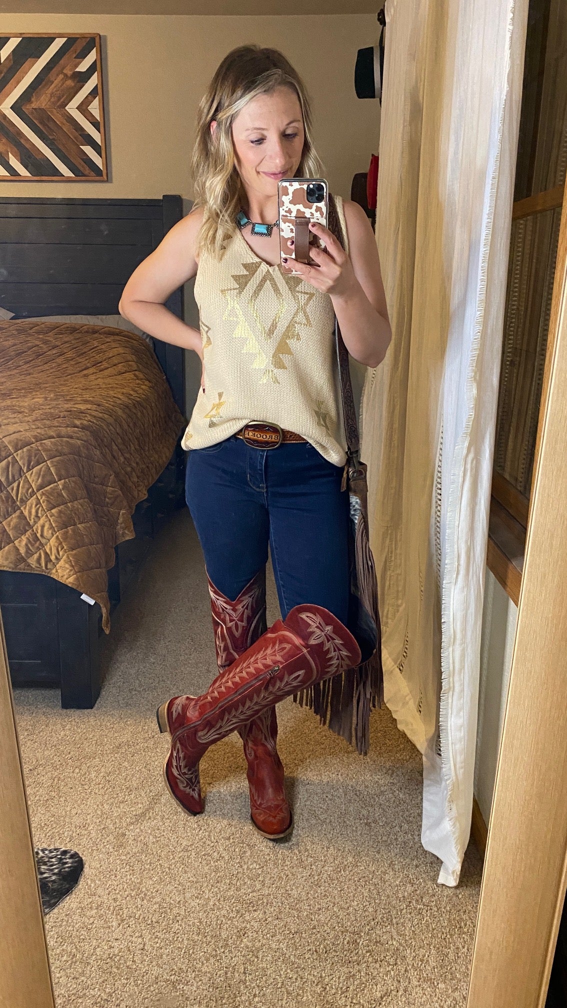 The Lane Lexington Over-the-Knee Boots [Smoldering Ruby] styled by a Broker Leather employee- she paired them with jeans and an Aztec tank top.