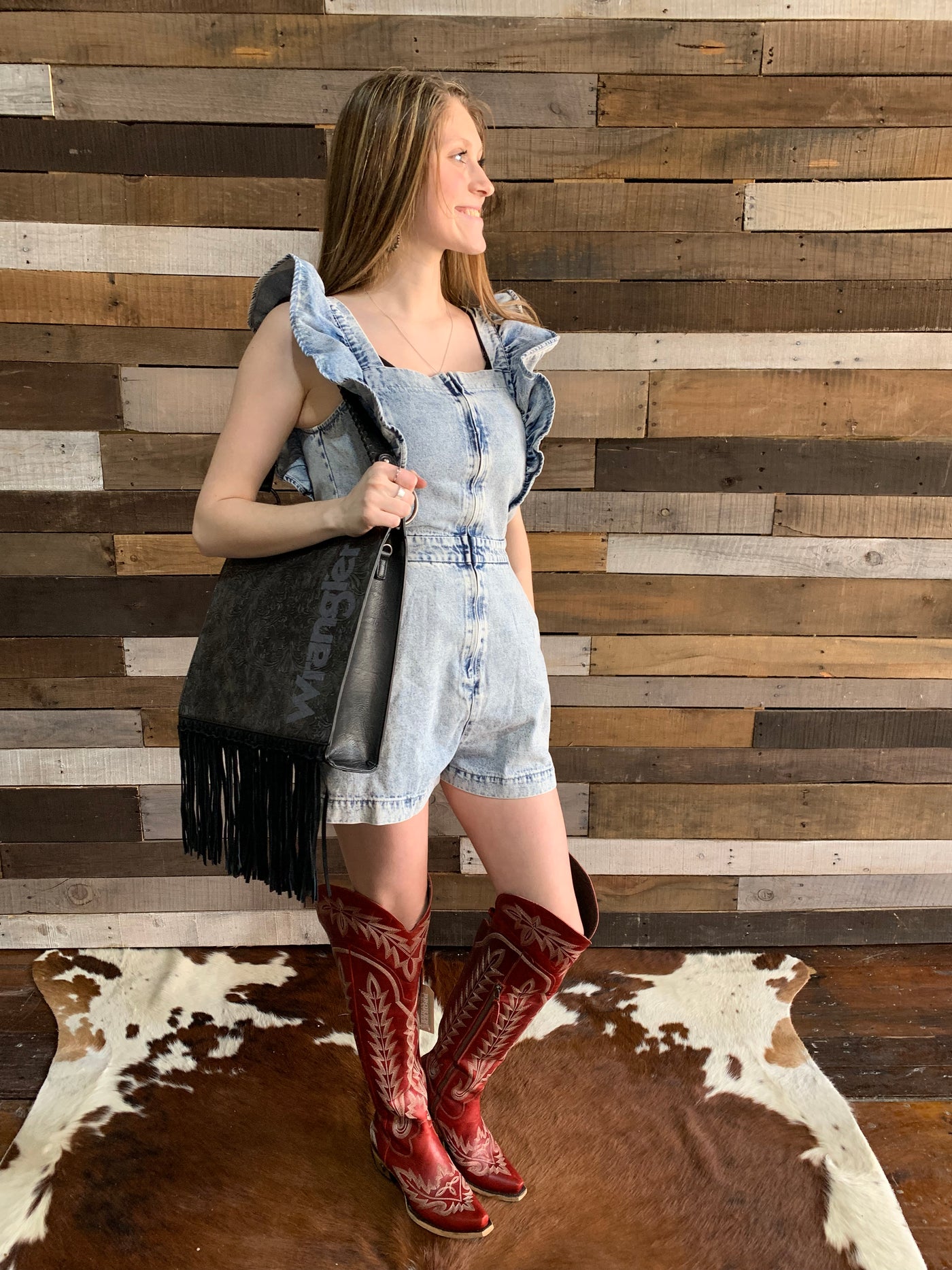 A front view showing the Lane Lexington Boots in smoldering ruby with laced corset back and over-the-knee fit will elevate any denim.