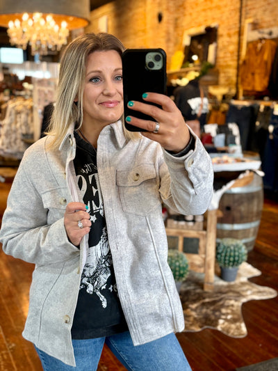 Brianne Huiskamp, Owner, modeling a full view of the relaxed fit Latte Heathered Grey Shacket, ideal for coffee runs or a laid-back day out.